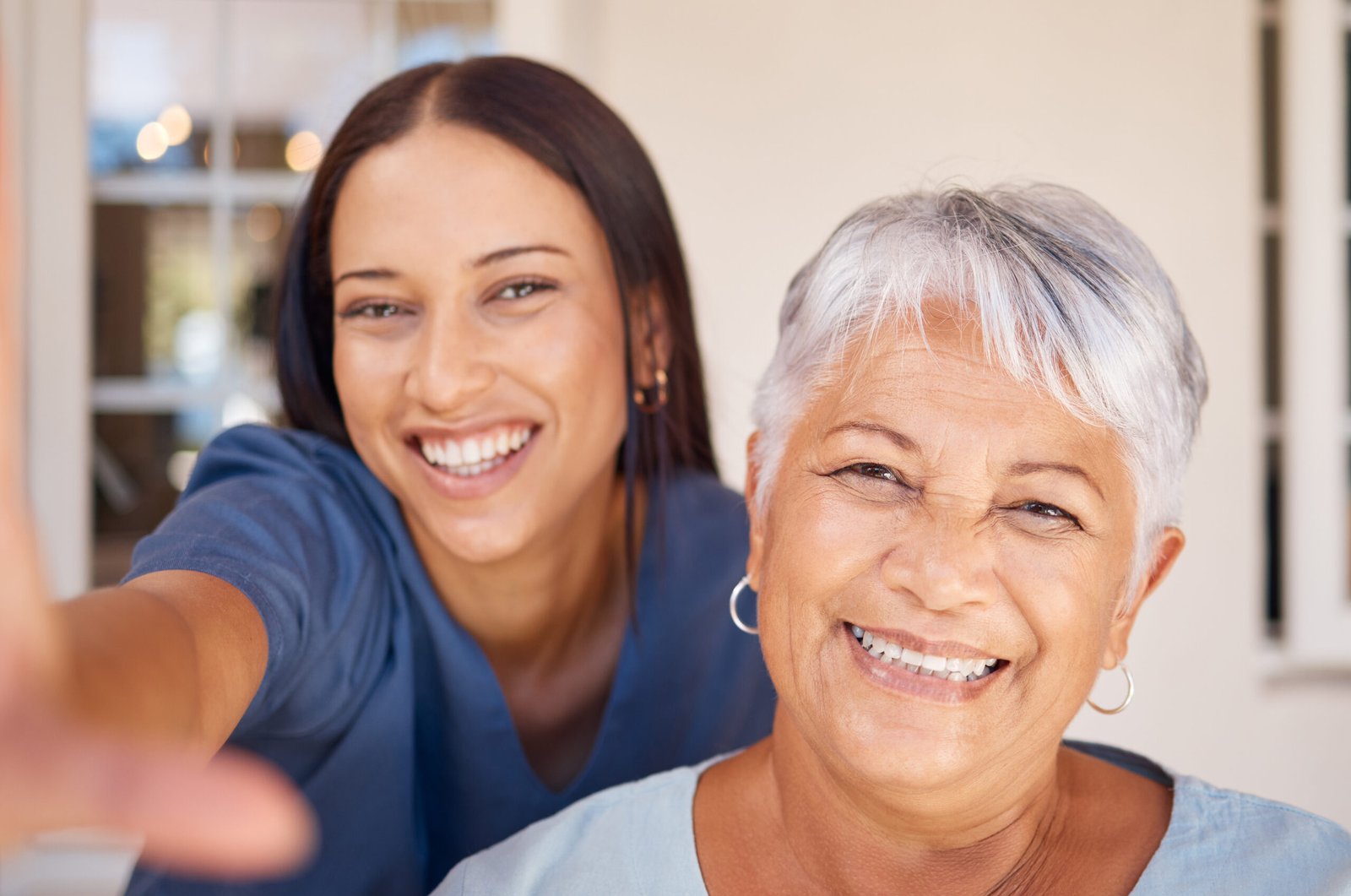 Healthcare, doctor and selfie portrait with elderly patient in living room, bonding during checkup at assisted living facility. Trust, senior care and nursing by friendly caretaker relax together.